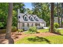 Charming exterior featuring a well-manicured front yard and inviting entrance to the Cape Cod-style home at 944 Pine Ridge Dr, Stone Mountain, GA 30087