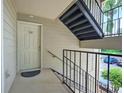 Apartment entrance featuring a staircase, a well-lit entryway, and a unit door at 4106 Chastain Park Ne Ct, Atlanta, GA 30342