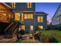 Exterior patio area with outdoor seating and lush landscaping that is perfect for outdoor relaxation at twilight at 440 Laurian Nw Way, Kennesaw, GA 30144