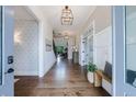 Elegant foyer with hardwood floors, modern lighting, designer wallpaper, and a glimpse of the staircase at 4992 Concert Ln, Marietta, GA 30066