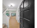 Bright foyer features light wood floors and staircase leading to the upper level of the home at 76 Forrest Pl, Atlanta, GA 30328