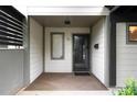 Close-up view of the home's front door with visible address number and secure screen door at 76 Forrest Pl, Atlanta, GA 30328