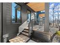 A modern home's covered porch with wooden decking and sleek metal railing details at 988 Mcdaniel Sw St, Atlanta, GA 30310
