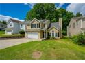 Inviting two-story home featuring a two-car garage and lush green lawn at 3454 Benthollow Ln, Duluth, GA 30096