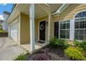 Front door with beautiful wreath, with black shutters and beige siding at 3454 Benthollow Ln, Duluth, GA 30096