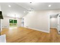 Spacious living room boasts hardwood floors, modern lighting, and sliding glass doors to a back deck at 4043 Chedworth Way, Stone Mountain, GA 30083