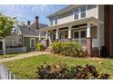 Beautiful craftsman home with a welcoming front porch, brick columns, green lawn, and lush landscaping at 513 Boulevard Se, Atlanta, GA 30312