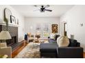 Inviting living room featuring a stylish fireplace, hardwood floors, large windows, and a comfortable sofa at 513 Boulevard Se, Atlanta, GA 30312
