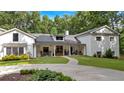 Charming exterior elevation featuring a well-manicured lawn and inviting front porch with rocking chairs at 1421 Hendon Rd, Woodstock, GA 30188