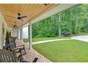 Inviting front porch with brick flooring and serene views of lush greenery at 1421 Hendon Rd, Woodstock, GA 30188