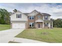 Charming two-story home with a manicured lawn, brick accents, and a convenient two-car garage at 238 Linford Dr, Locust Grove, GA 30248