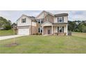 Beautiful two-story home featuring brick accents, landscaped yard, and a convenient two-car garage at 238 Linford Dr, Locust Grove, GA 30248