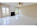 Comfortable living room featuring fireplace, large windows, and neutral walls creating a relaxing atmosphere at 3601 Gainesway Trce, Duluth, GA 30096