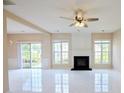 Spacious living room with modern fireplace, sleek tile floors, and sliding door access to the outdoors at 3601 Gainesway Trce, Duluth, GA 30096