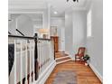 Bright hallway with hardwood floors, chair rail detail, and a view of the staircase at 4676 Ivygate Se Cir, Atlanta, GA 30339
