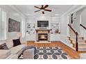 Cozy living room featuring a fireplace with built-in shelves and hardwood floors at 4676 Ivygate Se Cir, Atlanta, GA 30339