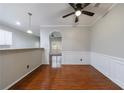 Elegant dining room featuring wainscoting, modern lighting, and gleaming hardwood floors at 4844 W Park Cir # 4844, College Park, GA 30349