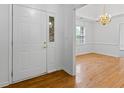 Elegant foyer with hardwood floors, stylish lighting, and a glimpse into the living area at 55 Fox Chase, Covington, GA 30016