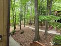 Exterior shot of the property showing the surrounding trees and walking path through the community at 5826 Par Four Ct, Lithonia, GA 30038