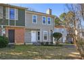 Charming two-story home with light grey siding, brick accents, and a well-manicured front yard at 107 Woodberry Ct, Woodstock, GA 30188