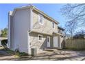 Rear exterior view of a light grey two-story home with a well-maintained backyard and white trim at 107 Woodberry Ct, Woodstock, GA 30188