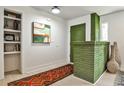 Inviting entryway featuring a vibrant green accent wall, built-in shelving, and stylish decor at 2568 Laurelwood Rd, Atlanta, GA 30360