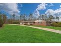 Charming brick home with large front lawn and driveway at 2716 Georgia 16, Carrollton, GA 30116