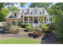 Beautifully landscaped brick home featuring a classic front porch and well-maintained yard at 2936 Summitop Ne Rd, Marietta, GA 30066