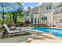 Beautiful backyard pool and patio area, perfect for entertaining and relaxation with a luxurious lounge chair at 2936 Summitop Ne Rd, Marietta, GA 30066