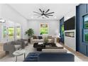 Bright living room featuring a fireplace, large ceiling fan, and elegant decor at 378 Grant Park Pl, Atlanta, GA 30315