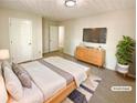 Staged main bedroom featuring a comfortable bed, sleek dresser, and ample natural light at 6370 Maid Marion Close, Alpharetta, GA 30005