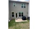 Backyard patio area with new gray vinyl siding and green grass at 6780 Cedar Glen Rd, Peachtree Corners, GA 30360
