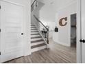 Bright foyer with hardwood floors, staircase, and white trim, leads to other rooms providing a welcoming entrance at 6780 Cedar Glen Rd, Peachtree Corners, GA 30360