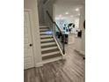 Staircase with wood treads and white risers leads to the kitchen and living area at 6780 Cedar Glen Rd, Peachtree Corners, GA 30360