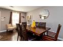 Dining room with a large wood table, seating for six, and natural light from a bright window at 3224 Canary Ct, Decatur, GA 30032