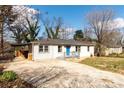 Well-maintained single-story home with a concrete driveway, bright blue front door and inviting front porch at 3224 Canary Ct, Decatur, GA 30032