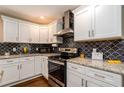 Updated kitchen boasting granite countertops, stainless steel appliances, and decorative tile backsplash at 3224 Canary Ct, Decatur, GA 30032