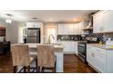 Kitchen featuring modern appliances, granite countertops, and sleek white cabinets with black backsplash at 3224 Canary Ct, Decatur, GA 30032