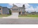 Inviting two-story home with a brick and siding exterior, well-manicured lawn, and attached garage at 320 Tulip Dr, Covington, GA 30016