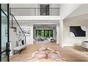 Grand foyer featuring soaring ceilings, wood floors, staircase with black iron railings, and an open floor plan at 4785 Merlendale Ct, Atlanta, GA 30327
