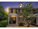 Charming brick townhome featuring black shutters, dormer windows, and a welcoming covered entrance at 6700 Roswell Ne Rd # 25A, Sandy Springs, GA 30328
