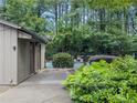 Pool restrooms and outdoor shower with landscaping, and a glimpse of the pool in the background at 2610 Cumberland Ct, Smyrna, GA 30080