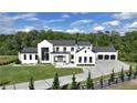 Striking modern farmhouse with black-framed windows, manicured lawn, and a spacious driveway at 5160 Howard Rd, Cumming, GA 30040