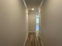 Neutral hallway with wood-look flooring leads to other rooms at 257 Depot Landing Rd # 39, Auburn, GA 30011
