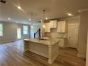 Open kitchen featuring a granite island, stainless steel sink, and ample cabinet space at 257 Depot Landing Rd # 39, Auburn, GA 30011