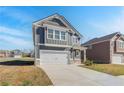 Charming two-story home with gray siding, white trim, a covered entrance, and a two-car garage at 266 Tulip Dr, Covington, GA 30016