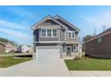 Charming two-story home with gray siding, white trim, a covered entrance, and a two-car garage at 266 Tulip Dr, Covington, GA 30016