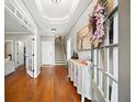 Inviting foyer with hardwood floors, a decorative table, beautiful art, and a staircase leading to the upper level at 3857 Felton Hill Sw Rd # 9, Smyrna, GA 30082