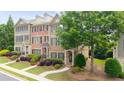 Well-maintained townhome with inviting curb appeal, lush landscaping, and a sidewalk leading to the front entrance at 3857 Felton Hill Sw Rd # 9, Smyrna, GA 30082