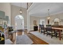 Elegant foyer featuring hardwood floors, a grand staircase, and a dining area at 4566 Fountain Ne Dr, Marietta, GA 30067